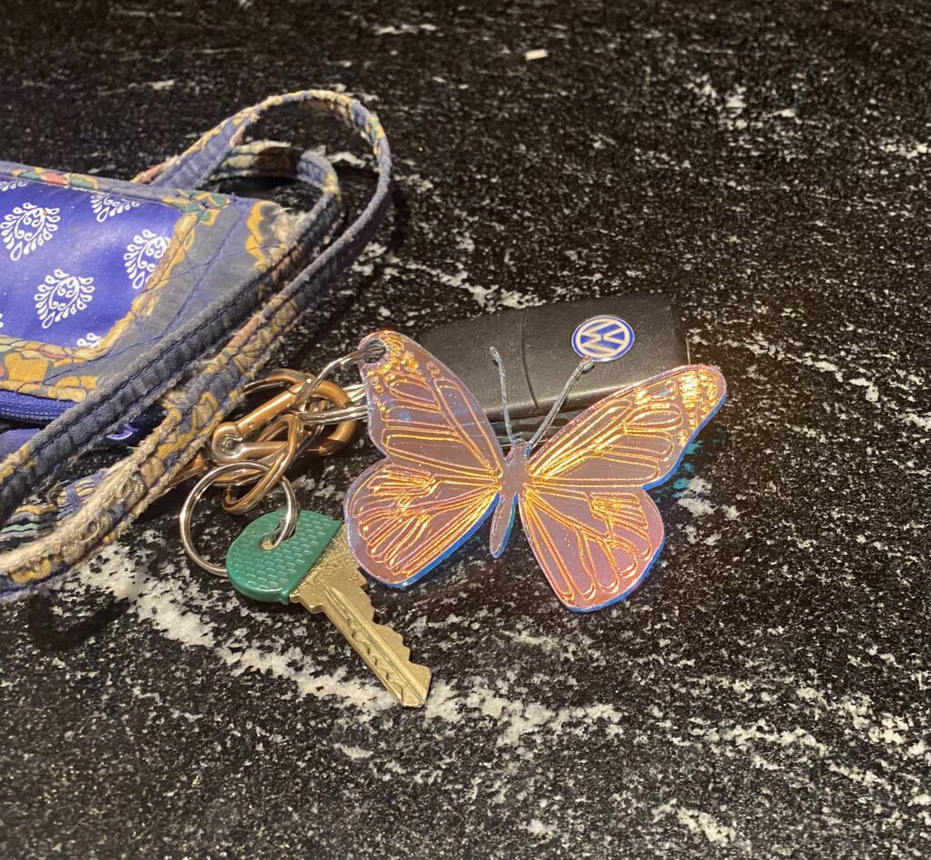 Photograph of laser cut acrylic butterfly keychain.